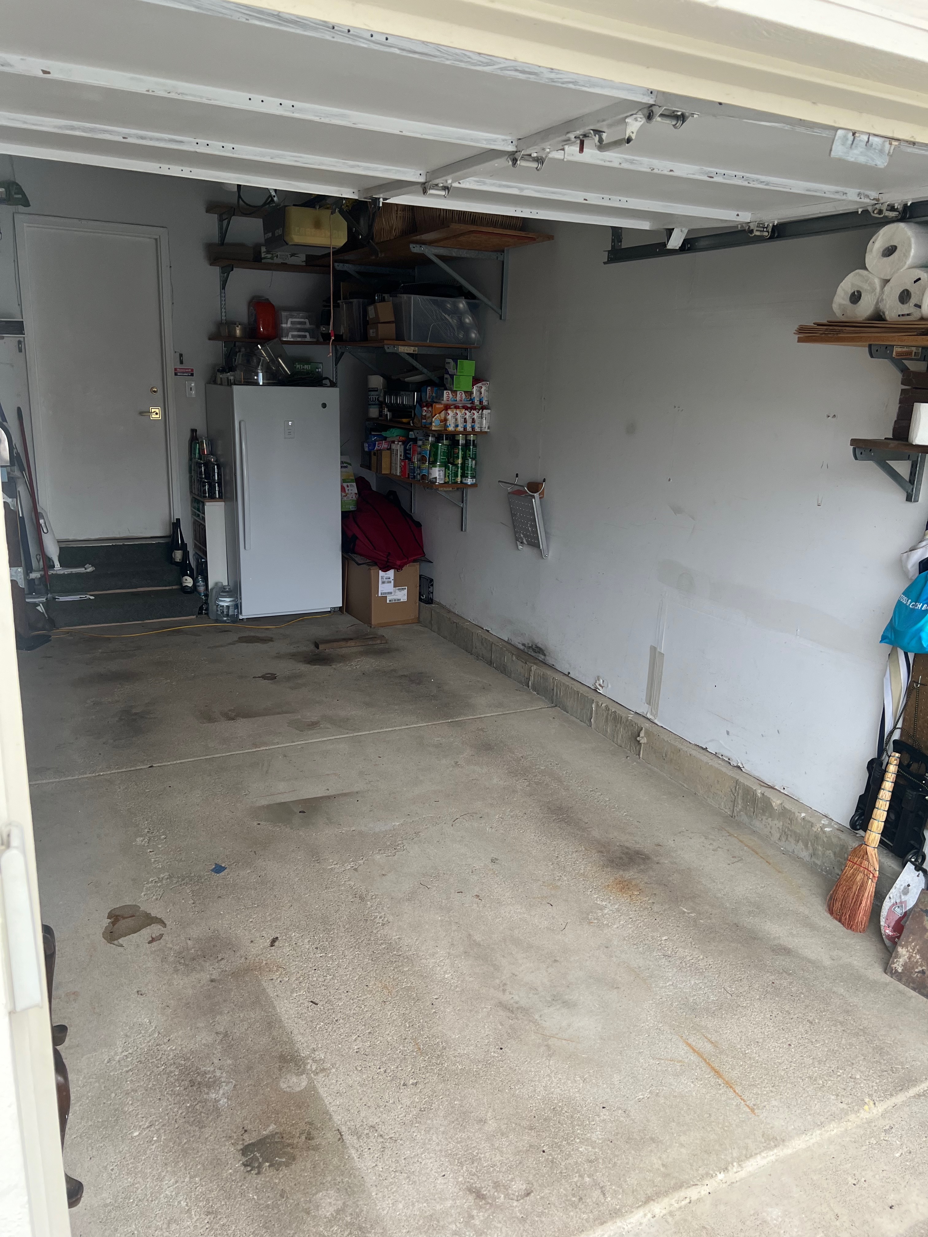 Overflowing green construction dumpster filled with cardboard boxes and building waste at urban construction site