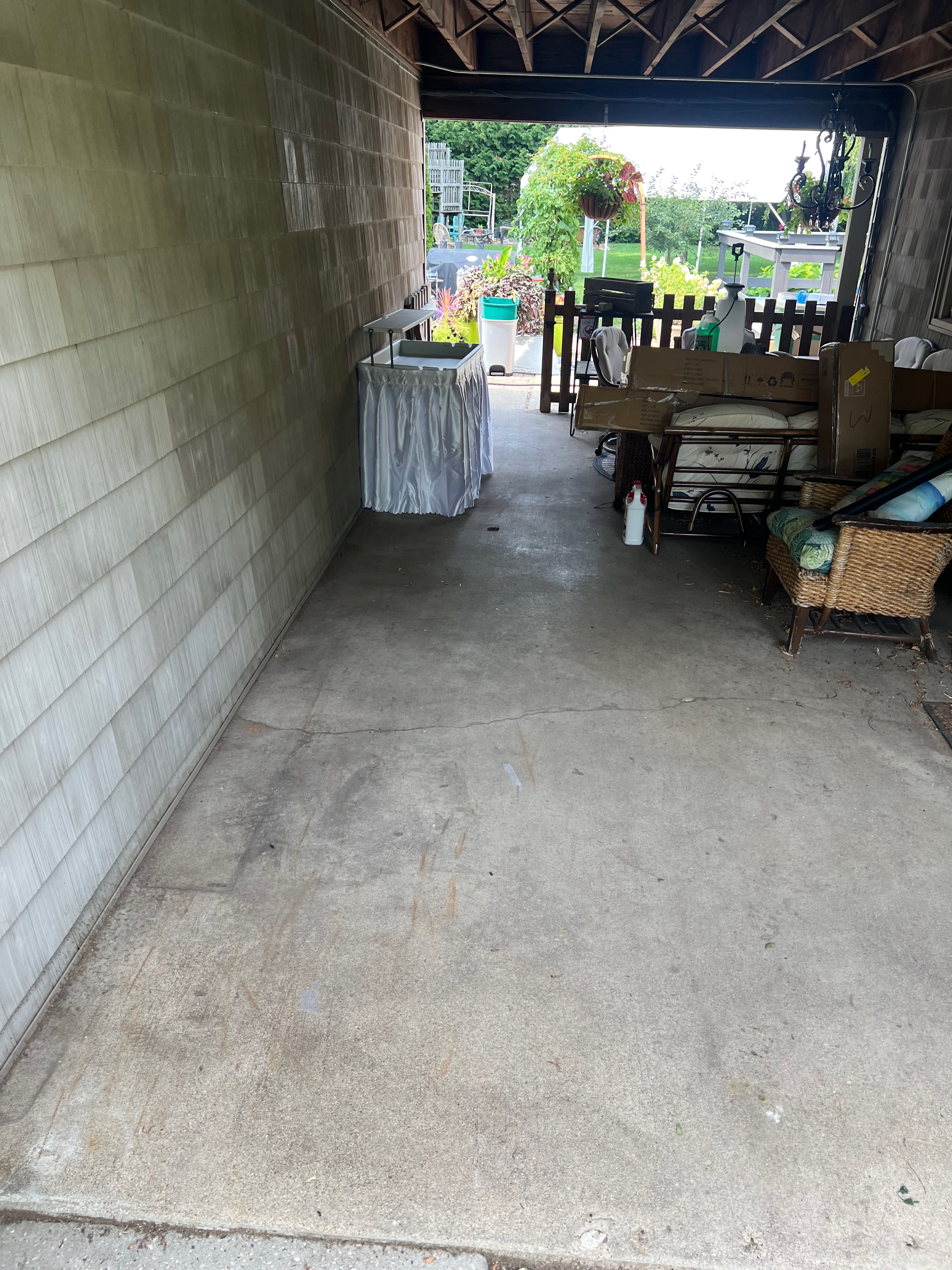 Garbage truck picking up trash bins on suburban street side.